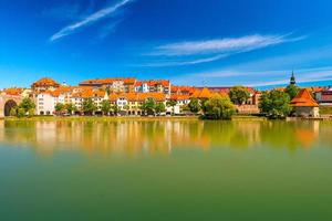 Cityscape of Maribor reflected in the water, Slovenia photo