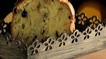 Panettone on wooden table, background with flashing lights video