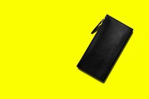 Fashionable leather women's wallet on a yellow background. added copy space for text. photo