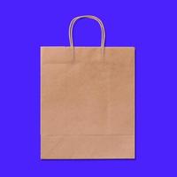 Luxury recycled paper shopping bag isolated on blue background. photo