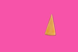 Cheese piece in Creative conceptual top view flat lay composition with copy space isolated on pink background in minimal style photo