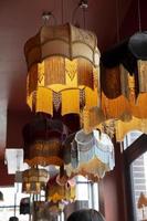 A textile chandelier shining by yellow light. photo