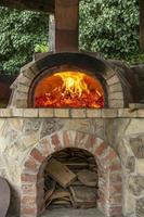 Burning firewood in a furnace, embers, glowing coals. photo