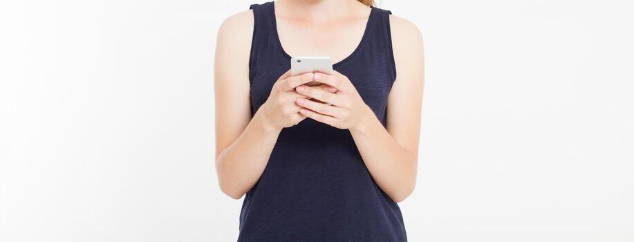 Girl holding white phone. Cellular isolated on white clipping path inside. Top view.Mock up.Copy space.Template.Blank. photo
