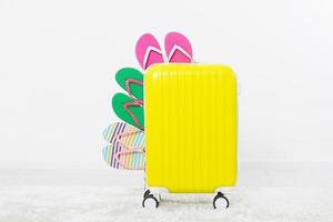 suitcase isolated on white background Summer holidays. summer flip flops or slippers.Sandals beach.Red cap.Travel valise or bag. Mock up. Copy space. Template. Blank. photo