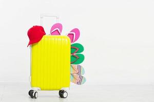 suitcase isolated on white background Summer holidays. summer flip flops or slippers.Sandals beach.Red cap.Travel valise or bag. Mock up. Copy space. Template. Blank. photo