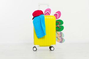 suitcase isolated on white background Summer holidays. summer flip flops or slippers.Sandals beach.Red cap.Travel valise or bag. Mock up. Copy space. Template. Blank. photo