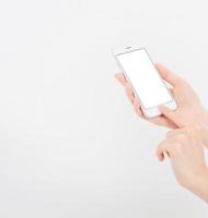 Hand holding white cellphone isolated on white clipping path inside. Online shopping. Top view. Mock up. Copy space. Template.Blank. photo