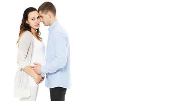 Young caucasian couple pregnant mother and happy father on white background, baby born photo