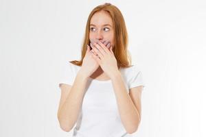 Young red-head woman covering her mouth, isolated on white, girl talk too much photo