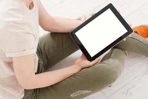 Girl sitting with tablet in hands. Online shopping.Top view.Mock up.Copy space.Template.Blank. photo