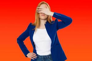 Woman do face palm, girl make facepalm, female migraine, head pain, bad feeling, tired woman - red background photo