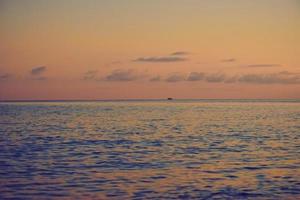 Sunset over the sea surface photo