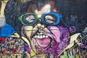 MEDELLIN, COLOMBIA, SEPTEMBER 12, 2019 - Street art of Comuna 13 in Medellin, Colombia. Once known as Colombias most dangerous barrio, today graffiti tour is one of most popular tourist attractions. photo