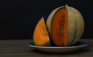 cantaloupe melon on black background photo