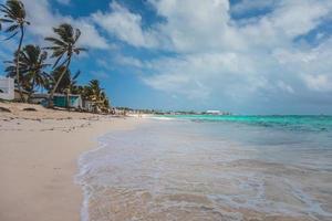Beach, Palm Trees and few People in Ocean of San Andres Island, Colombia. photo