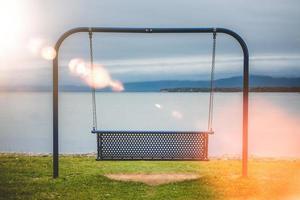 View to swings placed at ocean shore in Gaspe, New-Richmond, Quebec, Canada. photo