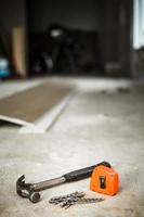 Hammer, Nails and Orange Measuring tape photo