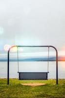 View to swings placed at ocean shore in Gaspe, New-Richmond, Quebec, Canada. photo