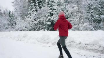 mujer, jogging, en, nevado, camino remoto