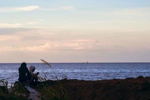 West Papua, Indonesia, 2021. Girl on beach, smartphone selfie. photo