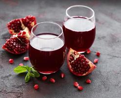 Pomegranate juice with fresh pomegranate fruits photo