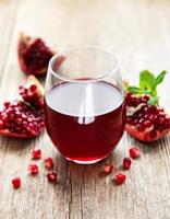 Pomegranate juice with fresh pomegranate fruits photo