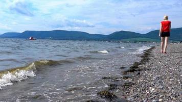 Slow Motion of a Woman Walking on the Sea Shore in Gaspe