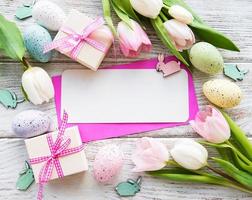 Gift boxes, easter eggs and tulips bouquet photo