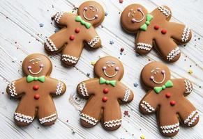 Christmas gingerbread men  on a white wooden background. photo