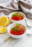 Red caviar in bowls photo