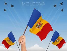 banderas moldavas volando bajo el cielo azul vector