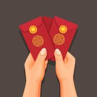 Hand holding angpao money on envelope, chinese new year celebrate concept in cartoon illustration vector