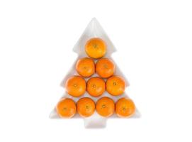 Bright orange ripe juicy tangerines in white plate, Christmas and New Year. photo