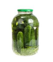 Glass jar with pickled cucumbers and herbs photo