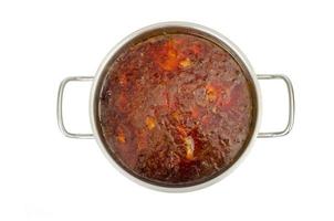 Saucepan with vegetable beetroot soup on white background.