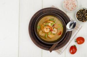 Spicy thai shrimp soup on plate. Studio Photo. photo