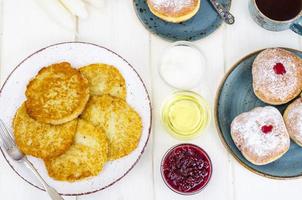Concept and background Jewish holiday Hanukkah. Traditional food doughnuts and potatoes pancakes latkes. Flat lay or top view. photo
