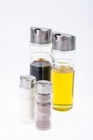 Set of glass bottles with olive oil, vinegar, salt and pepper for table setting