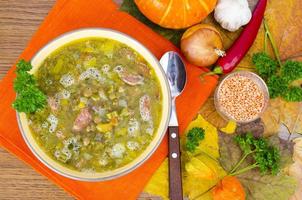 Soup from pumpkin, lentil and sausage. Photo