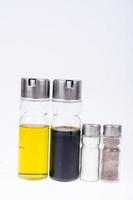 Set of glass bottles with olive oil, vinegar, salt and pepper for table setting