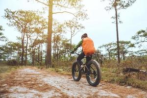 Asian women Travel photograph Nature. Travel relax ride a bike Wilderness in the wild. Thailand photo