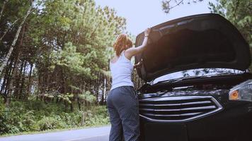 Women The car was broken on the highway. countryside. Women broken car photo