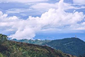 The mountain has a natural green tree in the rainy season and foggy blue sky in Thailand at Phu Tupberk. photo