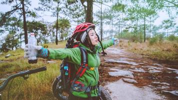 Asian women Travel photograph Nature. Travel relax ride a bike Wilderness in the wild. Thailand photo