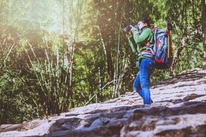 photographer Asian women Traveling photograph Nature. travel relax in the holiday walk in the forest. Thailand photo