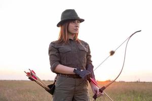 woman with bow outdoors in the field photo