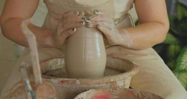 Close up of womans hand work with clay in pottery studio
