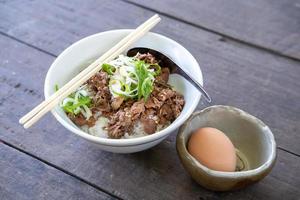 Japanese Gyudon or sliced beef cooked with sauce on rice. Serve with Onsen egg photo