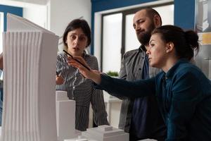 Professional team of architects analyzing maquette photo